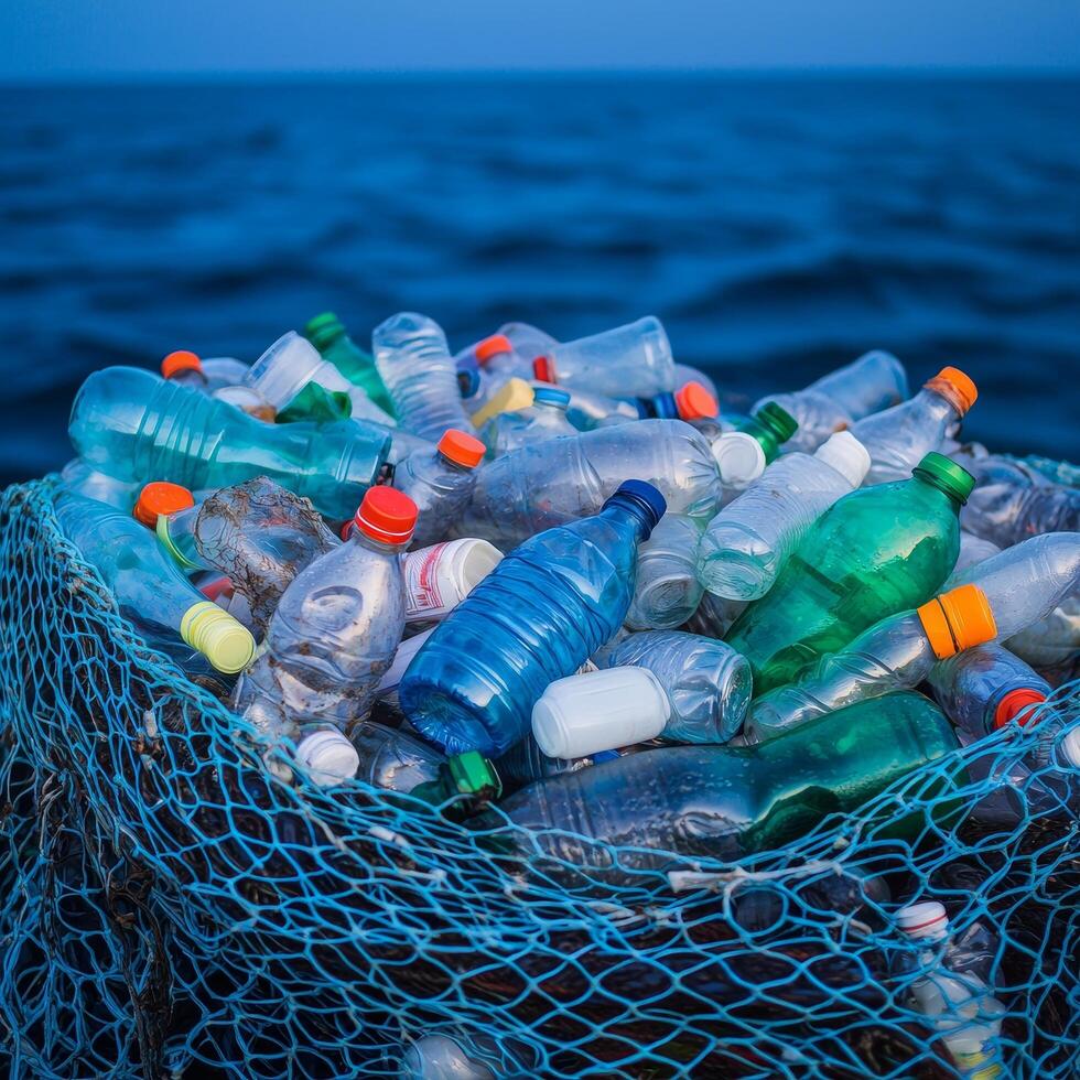 Plastic bottles collected in a net, floating on water. photo