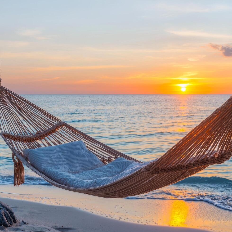 Hammock by the beach at sunset, creating a serene atmosphere. photo