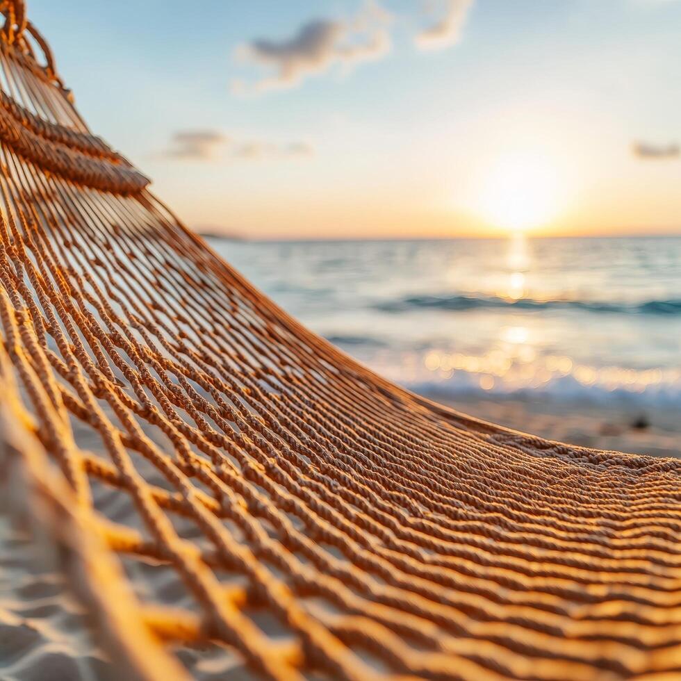 Hammock by the sea at sunset with soft waves in the background. photo