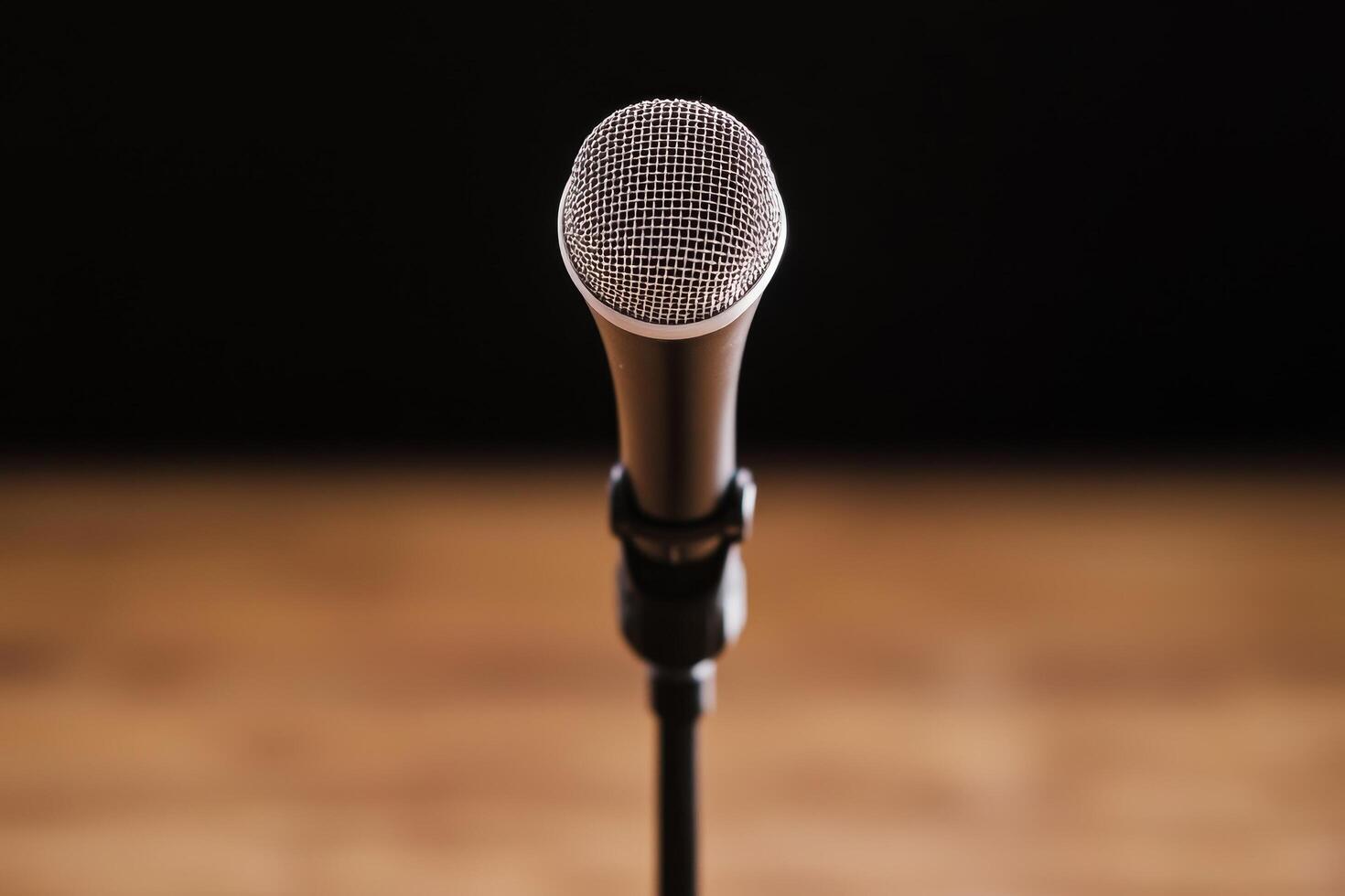 Microphone on a stand in a dimly lit environment. photo