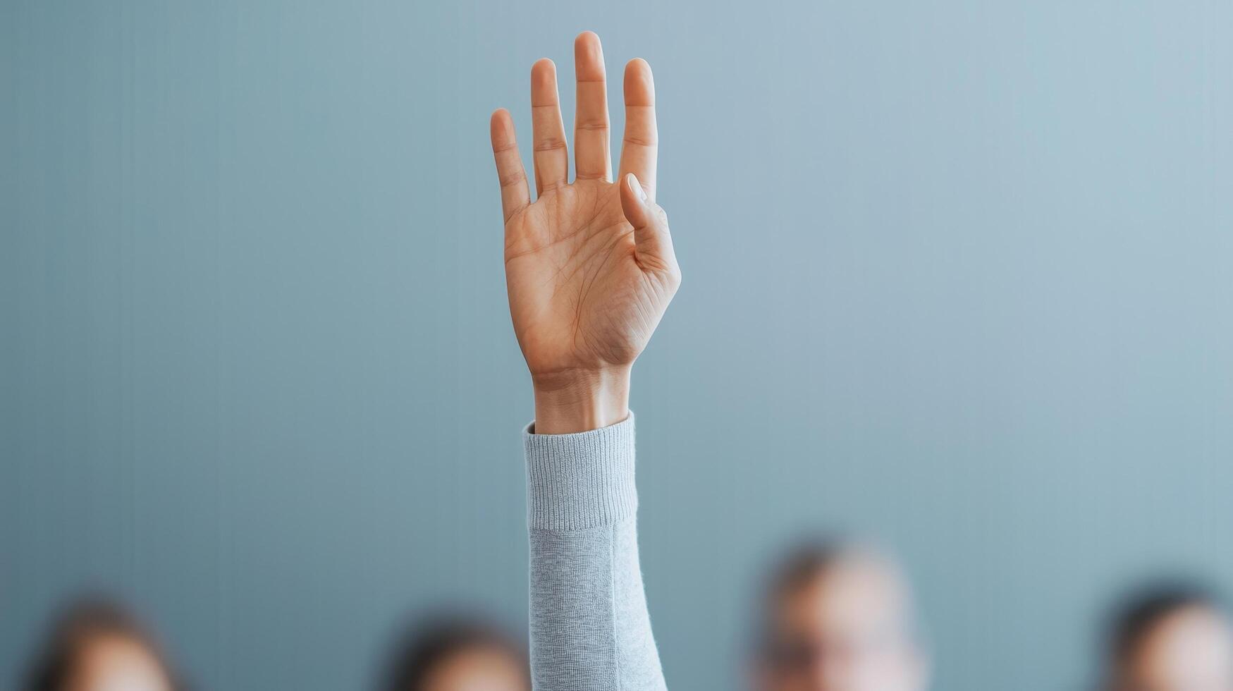 Raised hand in a classroom or meeting setting. photo