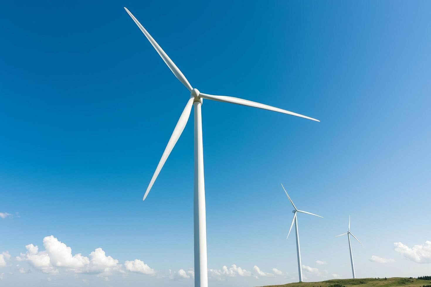 Wind turbines against a clear blue sky. photo