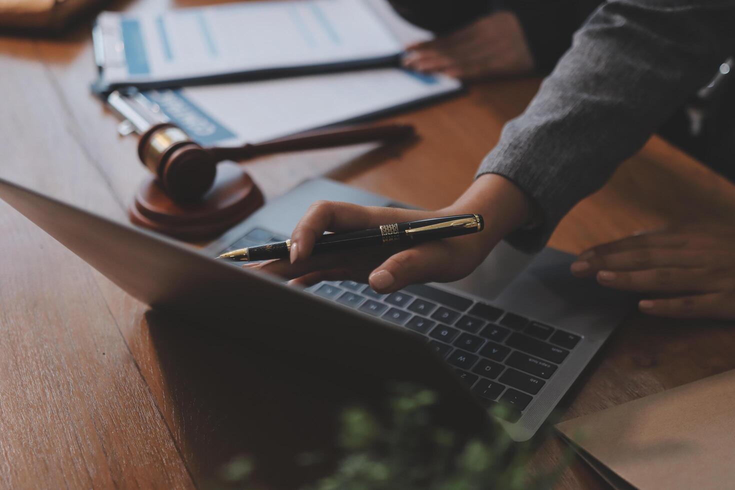 A lawyer's hand on a laptop photo