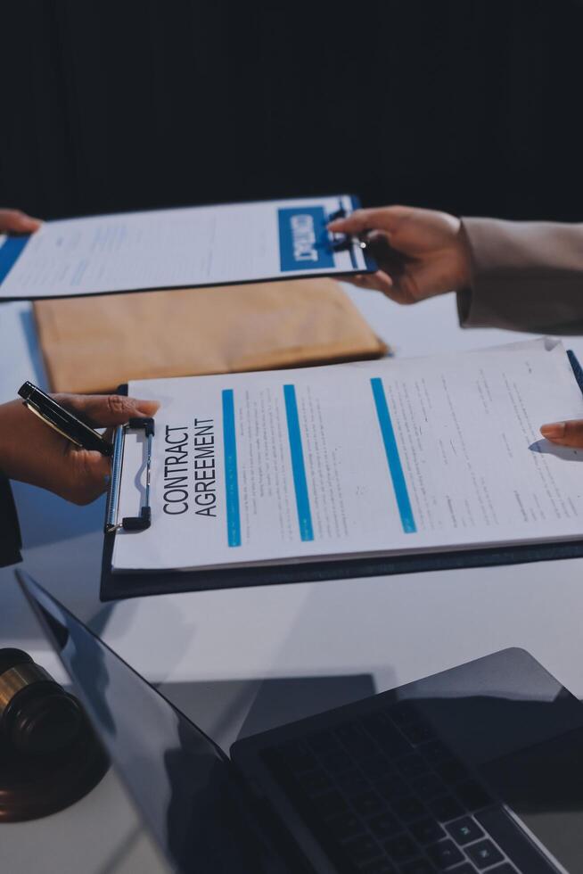 A group of people holding papers with the words contract photo