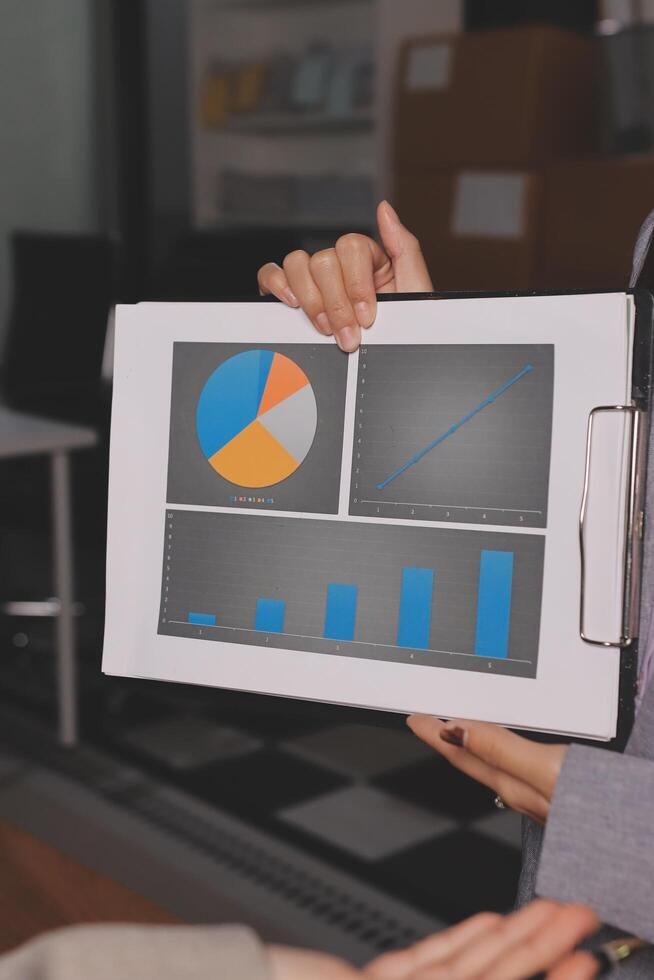 A person holding a clipboard with a graph on it photo