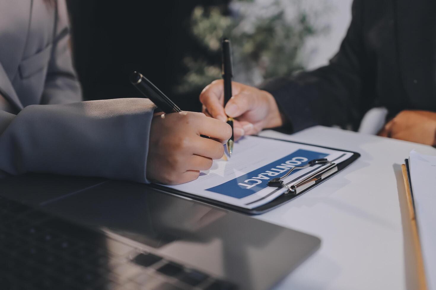 Businessman signing a contract with a client photo