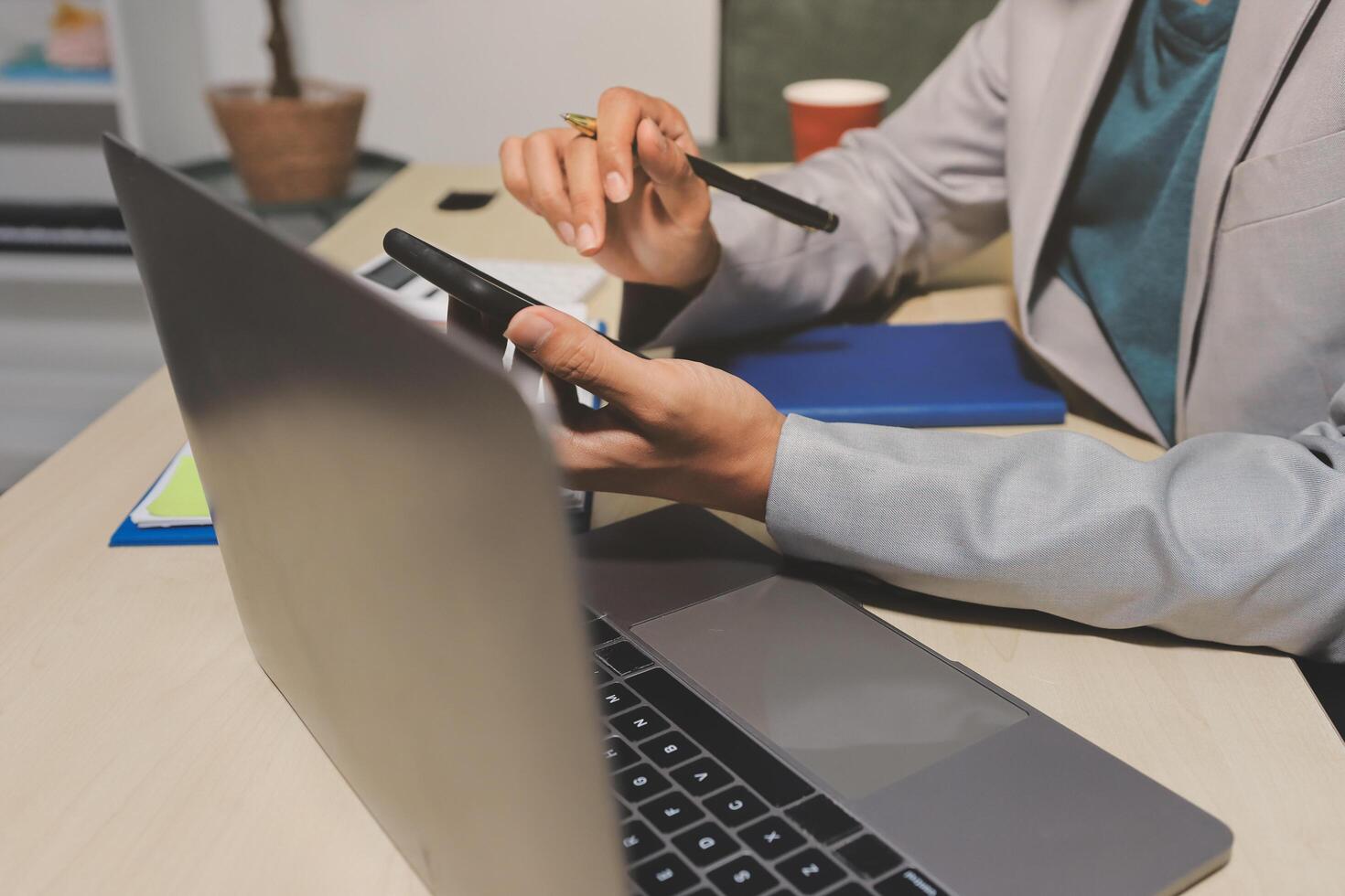 A person using a laptop and a pen photo