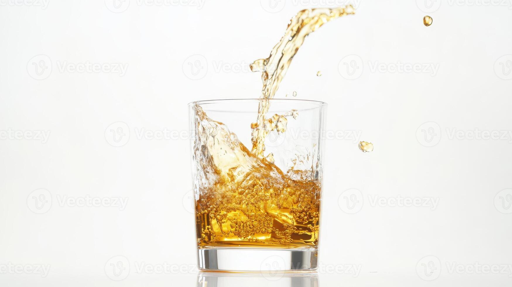 Refreshing splash of whiskey in a glass on white background for beverage concept. Stream of fuel pouring photo