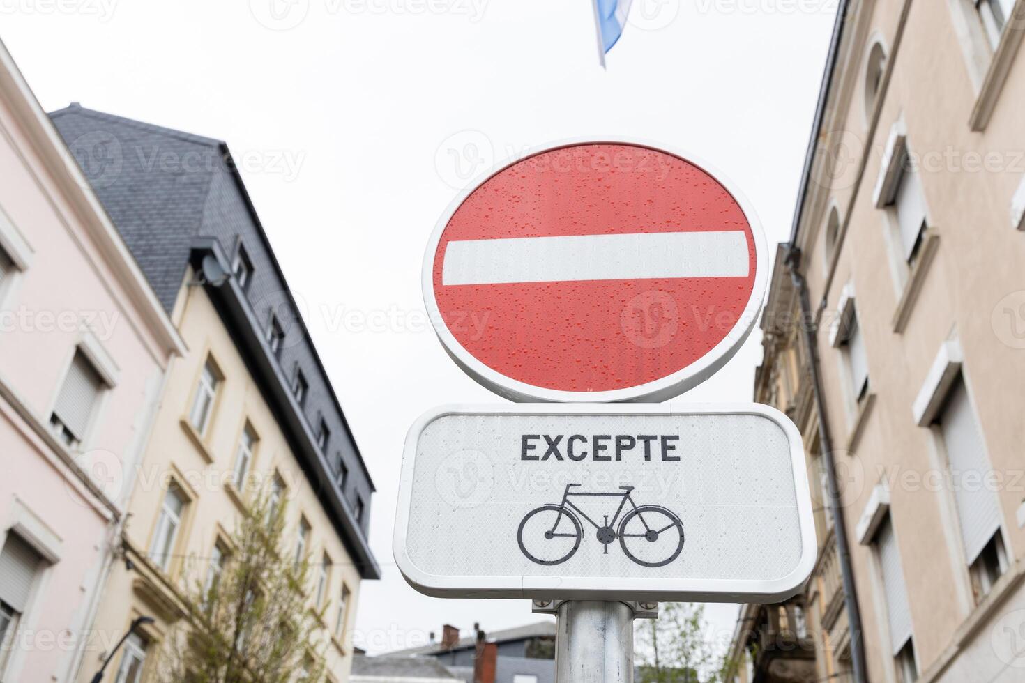 A bicycle street in Luxembourg with two road signs No entry, bicycles free and Bike street, each with a bicycle symbol. Old buildings in the background photo