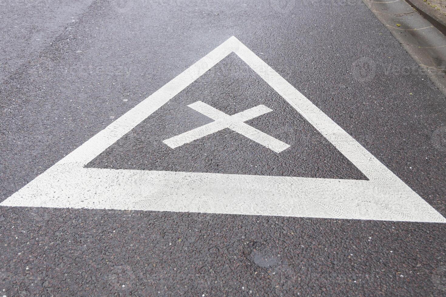 road sign of equal intersection painted on asphalt photo