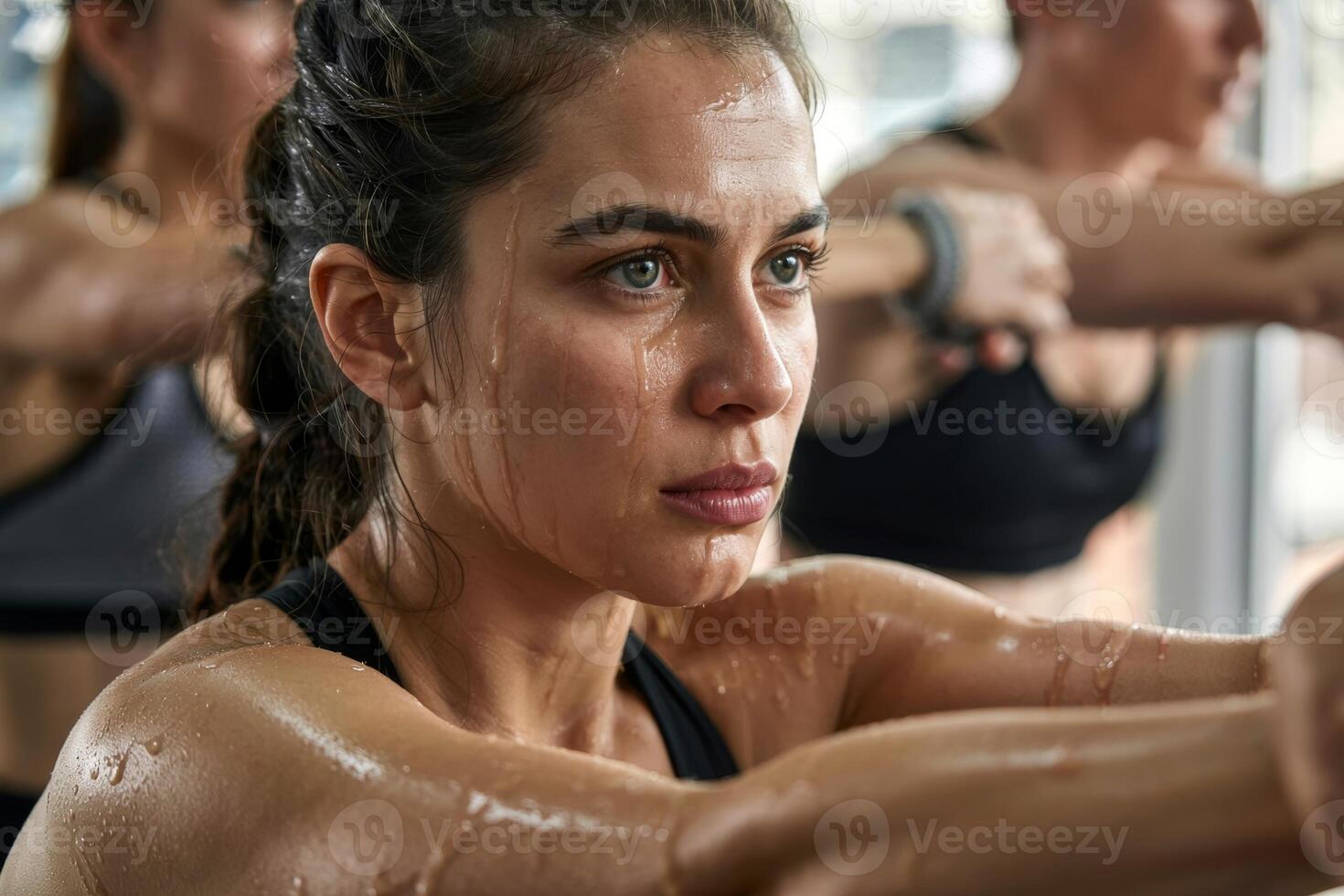 Focused determination shines through sweat during an intense training session in a modern gym photo