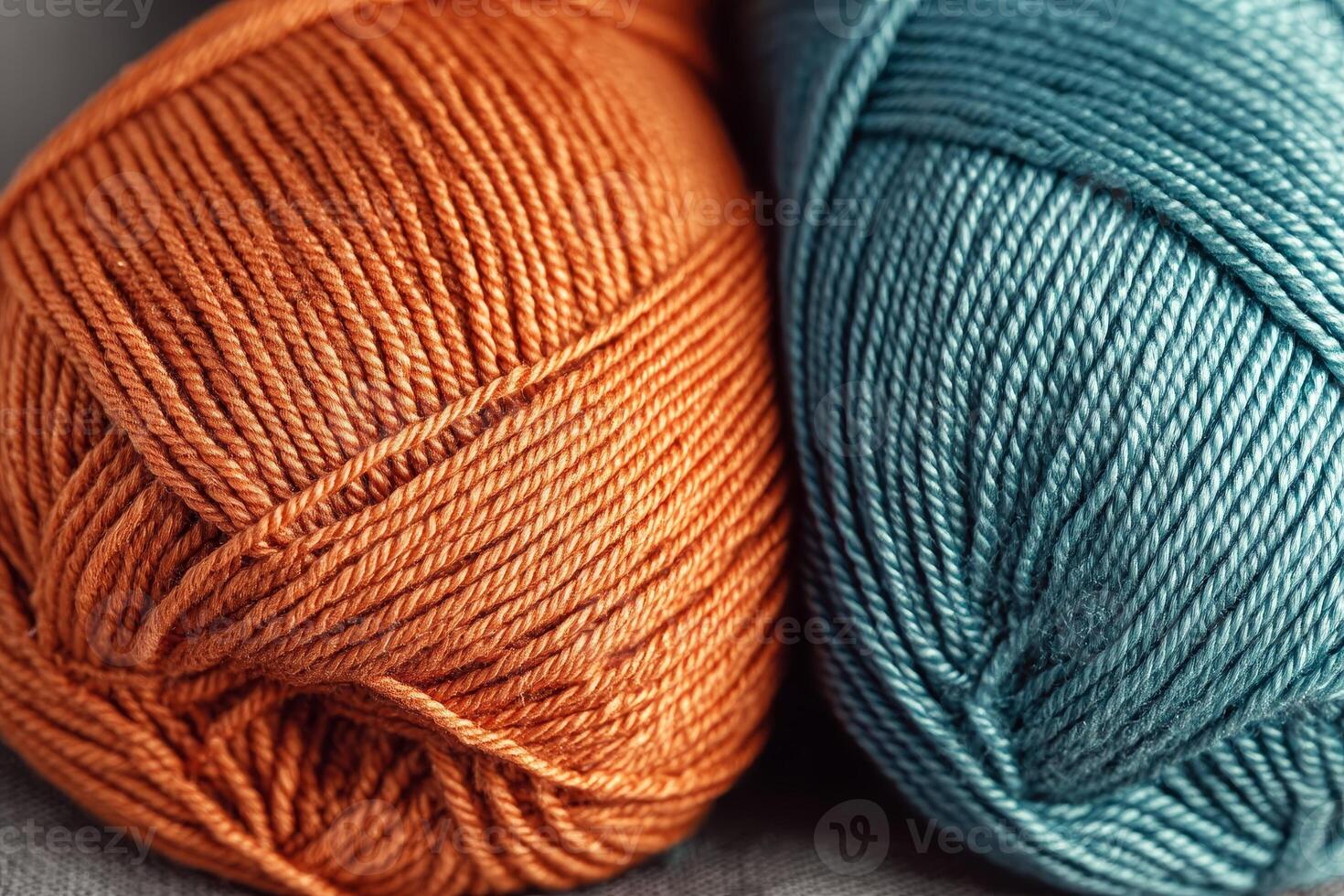 Colorful close-up of orange and teal blue yarns showcasing texture and creativity in knitting or crocheting photo