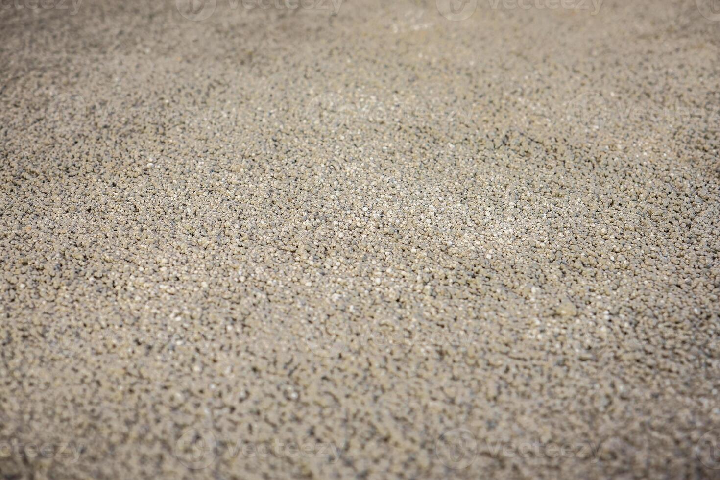 Detailed view of a textured surface made of small, evenly distributed pebbles, likely part of a flooring or underfloor heating construction process. photo