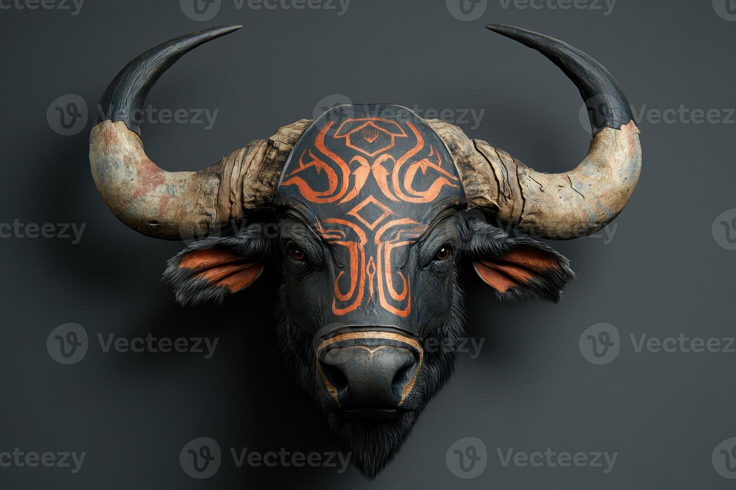 A large, black and orange bull head with a design on it photo