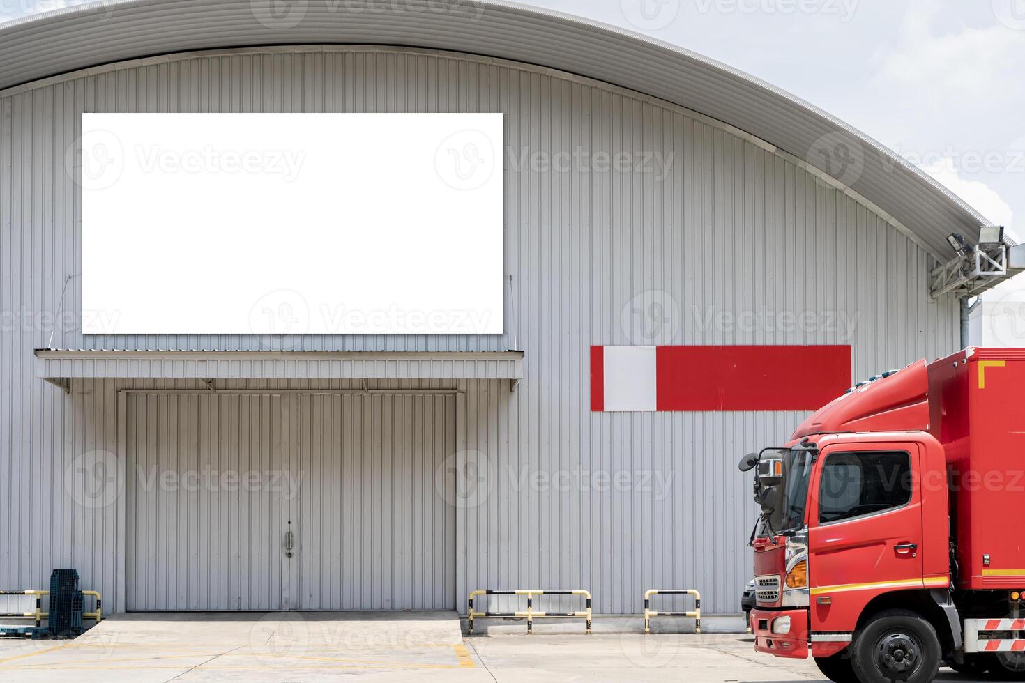Blank white billboard on building. Deliver industrial items, fleet of truck parked in front of the warehouse. photo