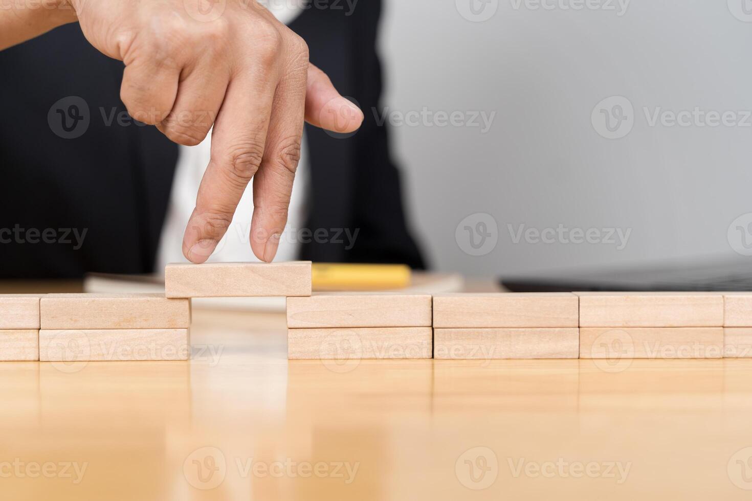 Businessman solving problems. Businessman hand walking across risk between wood blocks. photo
