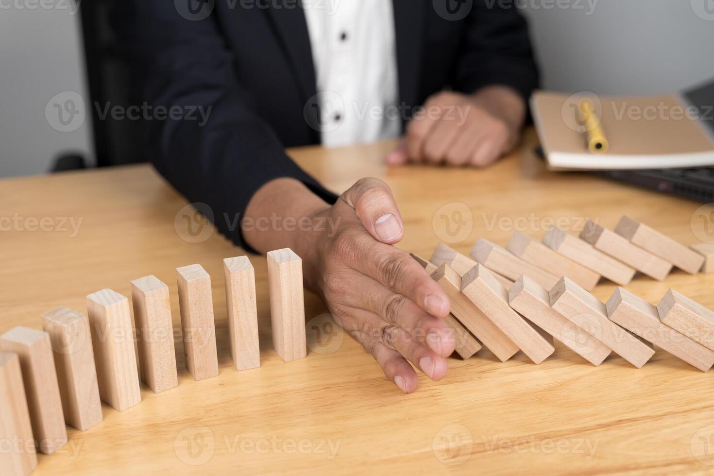 Businessman placing wooden blocks on tower risk control concept. Planning and strategy in business. photo