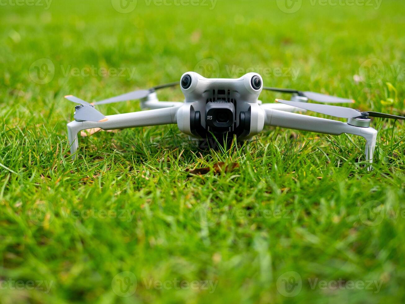 White drone a flying over a green field photo