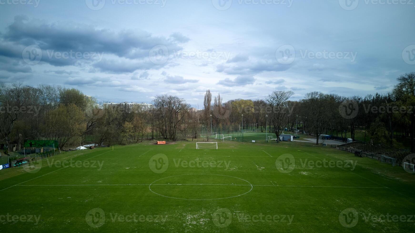 Large, empty soccer field with a cloudy sky in the background photo