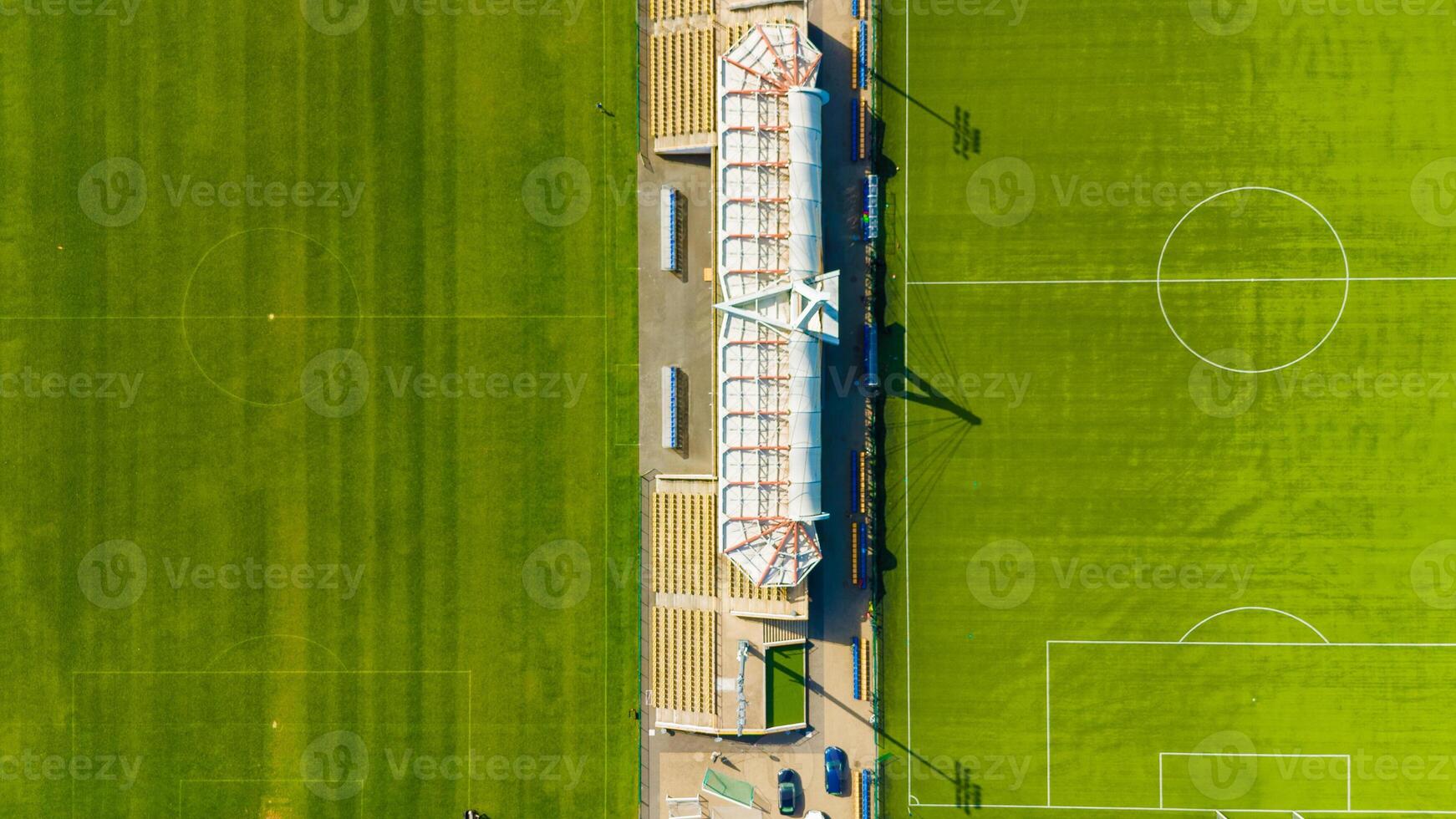 Soccer field with a large stadium in the background photo