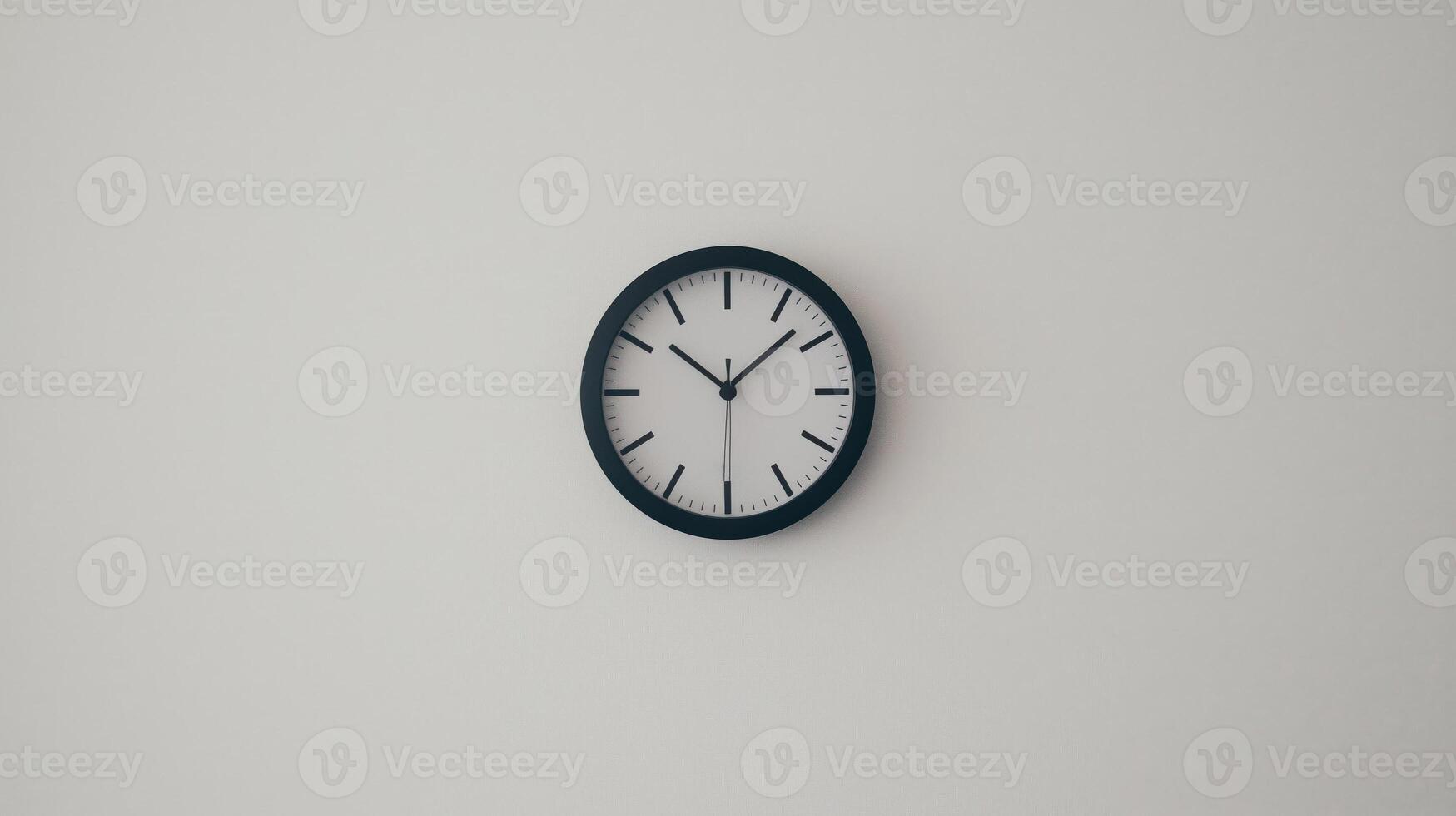 Black and white clock with the hands at the numbers 3 and 9 photo