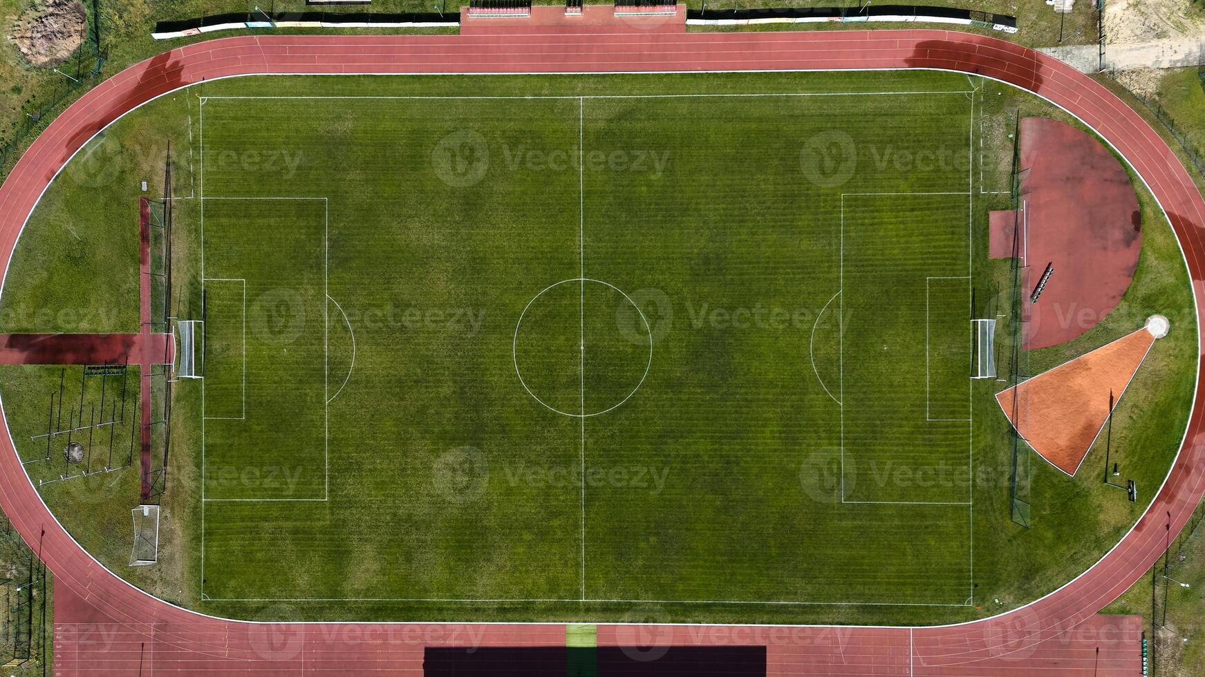 Aerial view of empty football field with running track photo