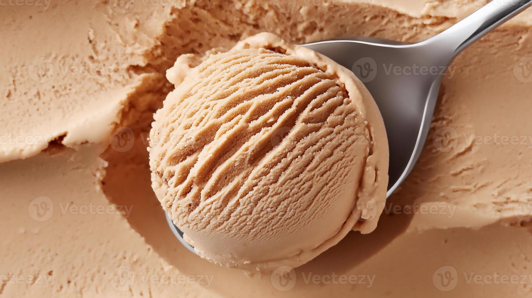 Creamy caramel ice cream scoop resting on a spoon against a smooth background of ice cream texture photo