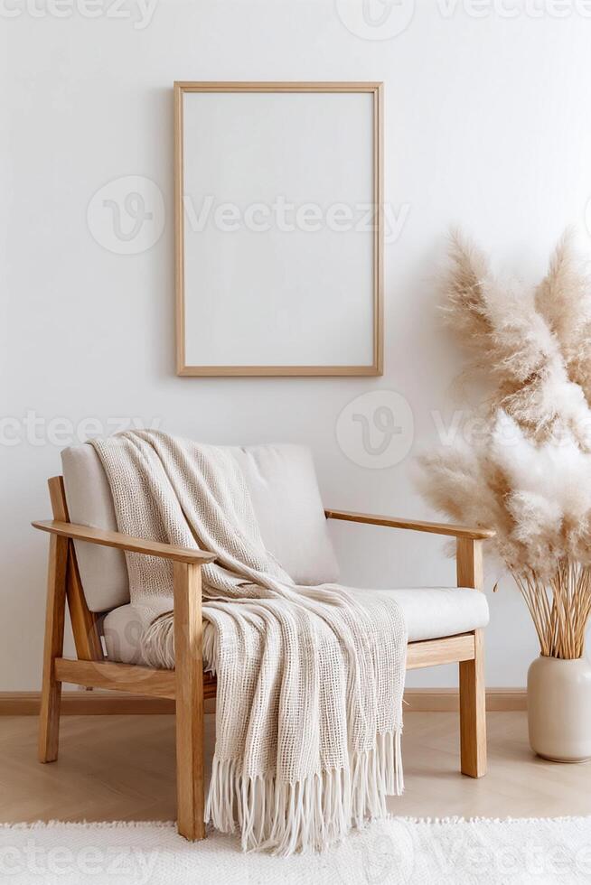 Comfortable chair with a cozy blanket and decorative plants in a minimalist boho indoor space with blank vertical frame for wall art mockup. photo