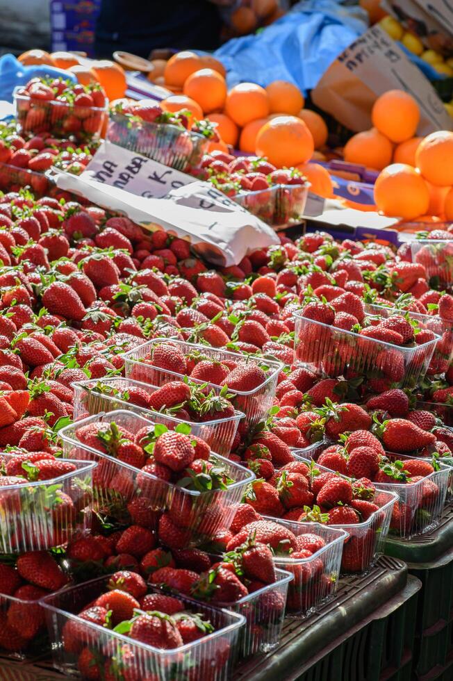 A close-up of ripe strawberries with green leaves, highlighting their freshness and vibrant color. photo