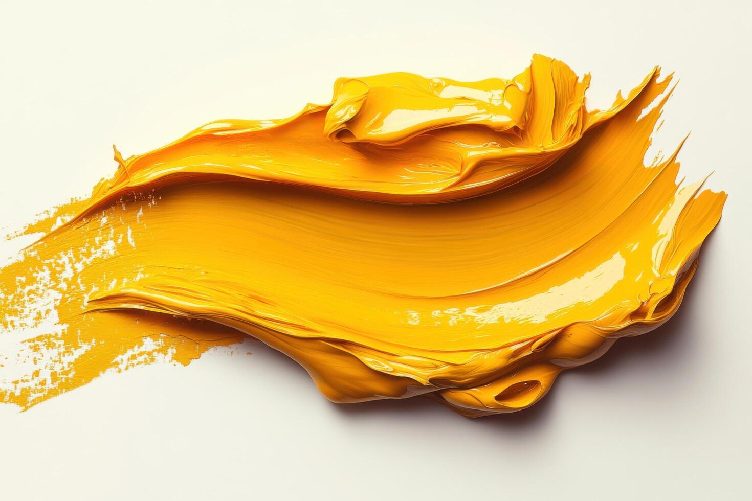 A yellow paint is being poured onto a white surface photo