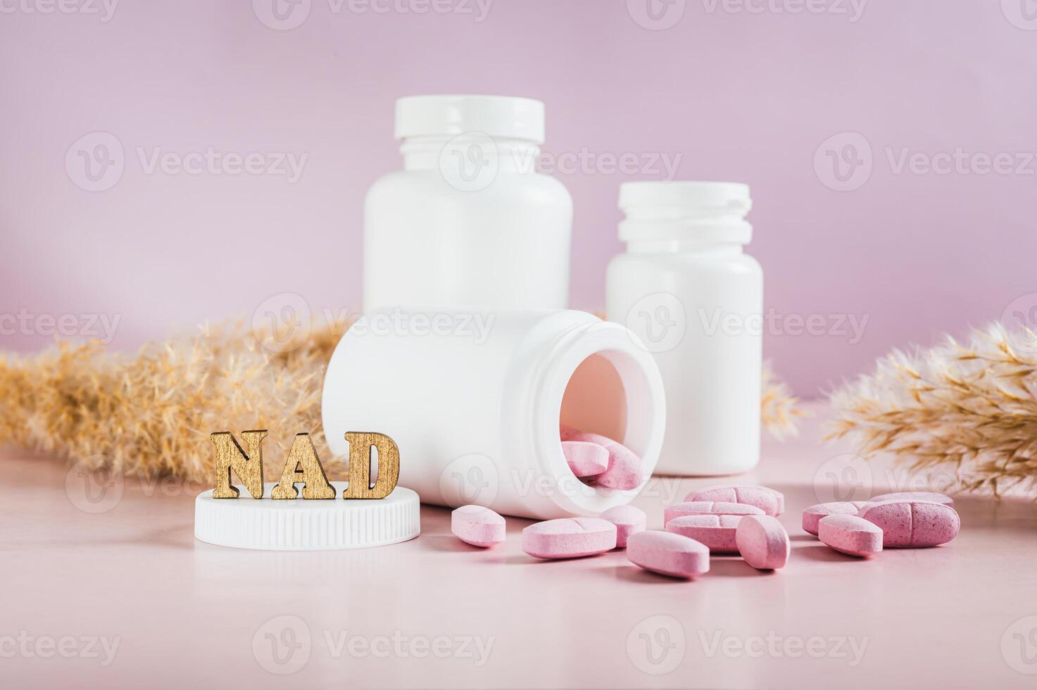 Nicotinamide adenine dinucleotide anti-aging pills and bottles on the table photo