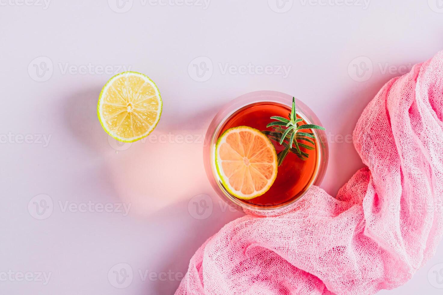 Closeup of alcoholic cocktail pink negroni with lime in glasses on table top view photo