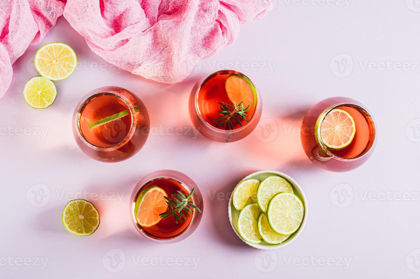 Alcoholic cocktail pink negroni with lime in glasses on table top view photo