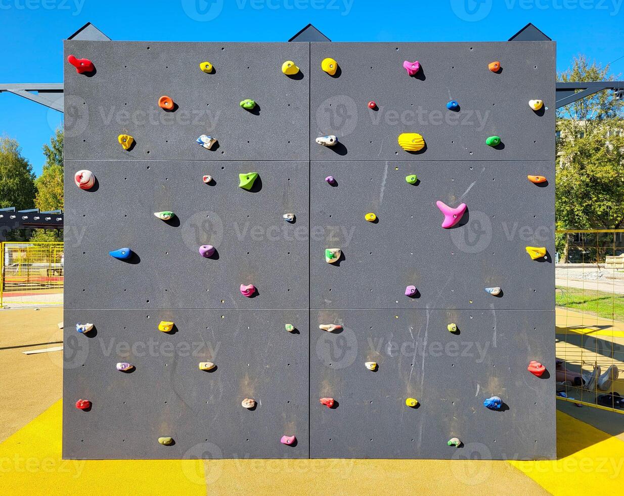 Climbing wall on the playground on a clear sunny day outside. photo