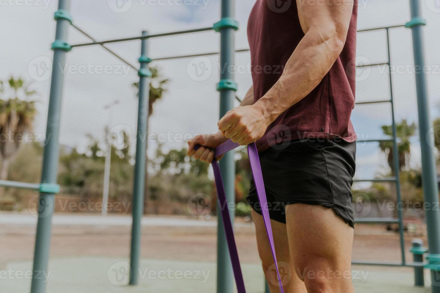 Close up of the hands of a man training with resistance photo