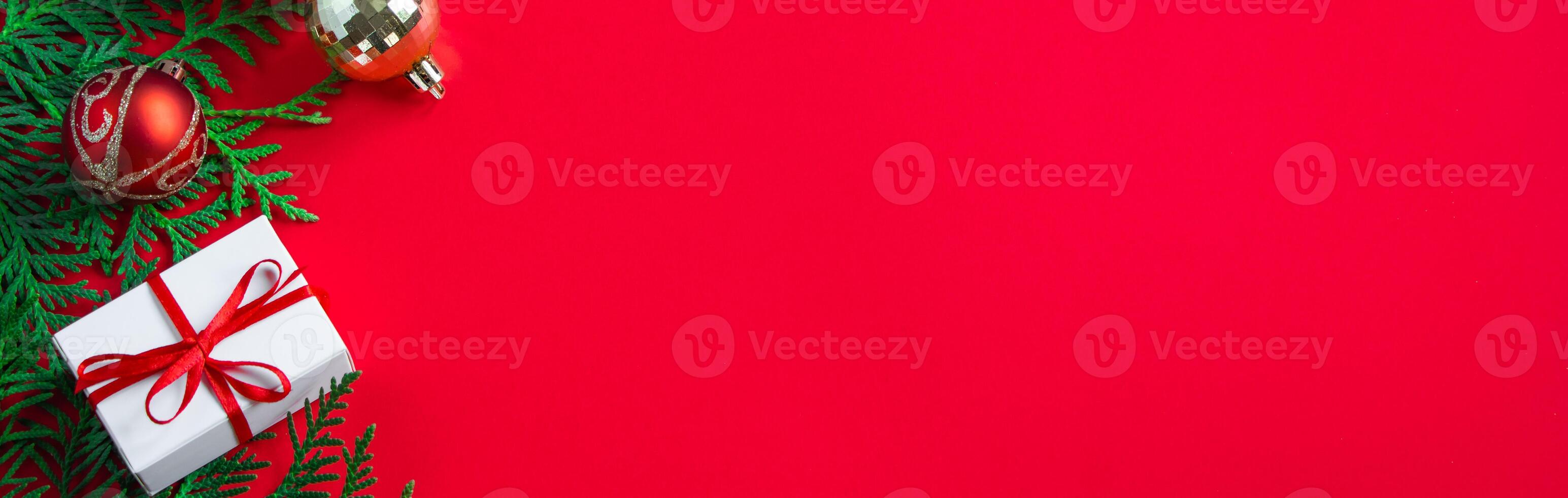 Christmas and new year concept. Gift boxes and decor on red background. photo