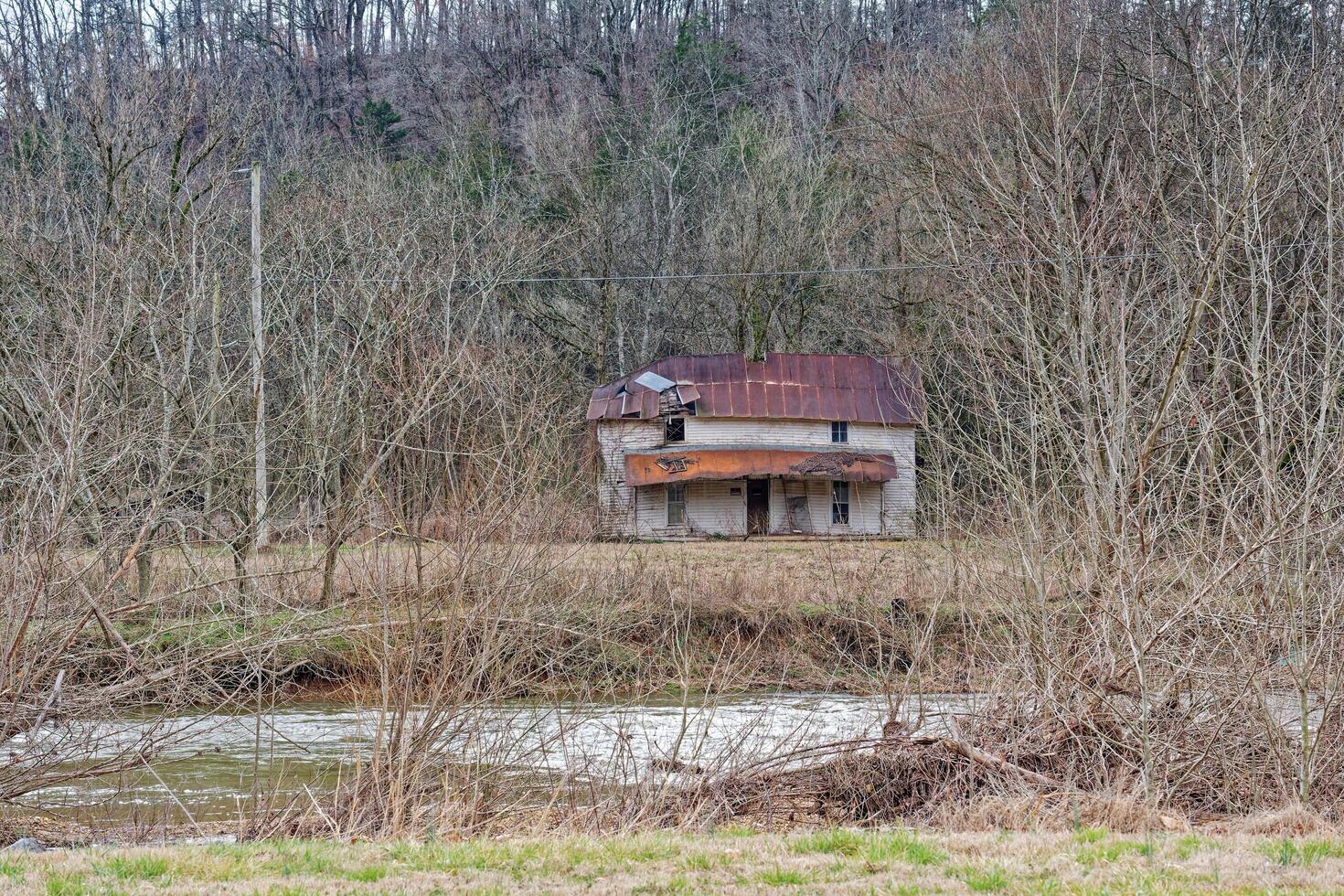 Abandoned homestead along a creek photo