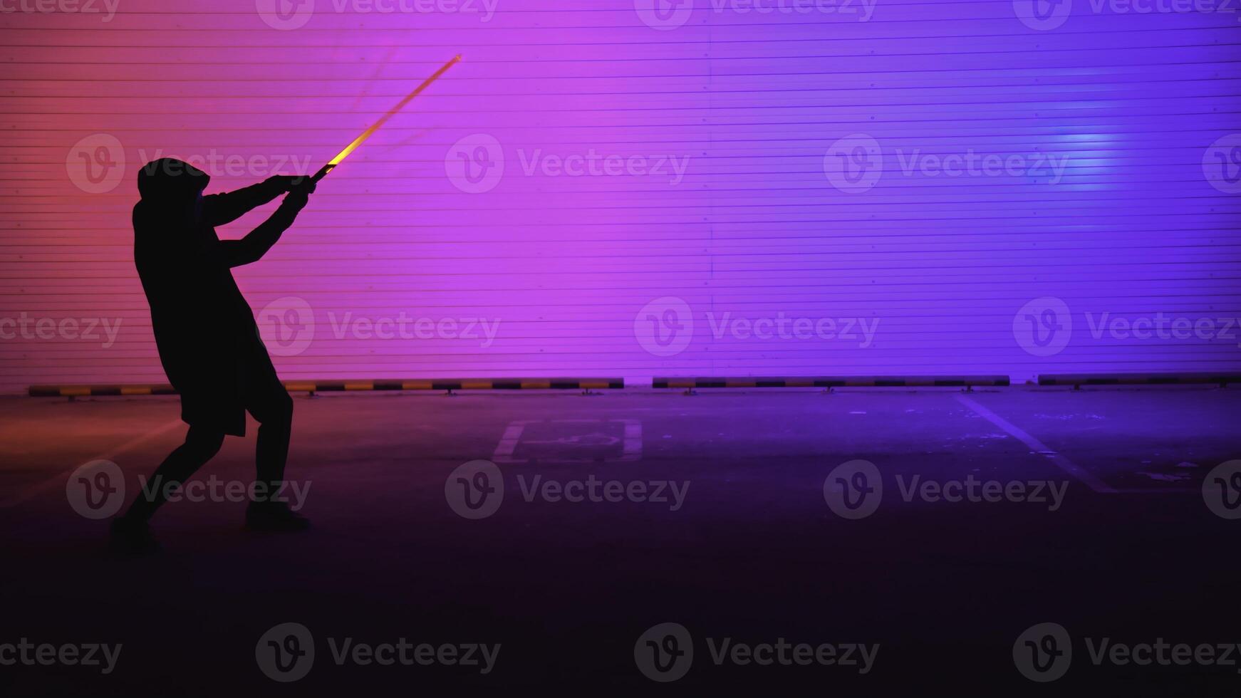 A striking neon silhouette illuminated by light in a bustling urban environment at night. Media photo