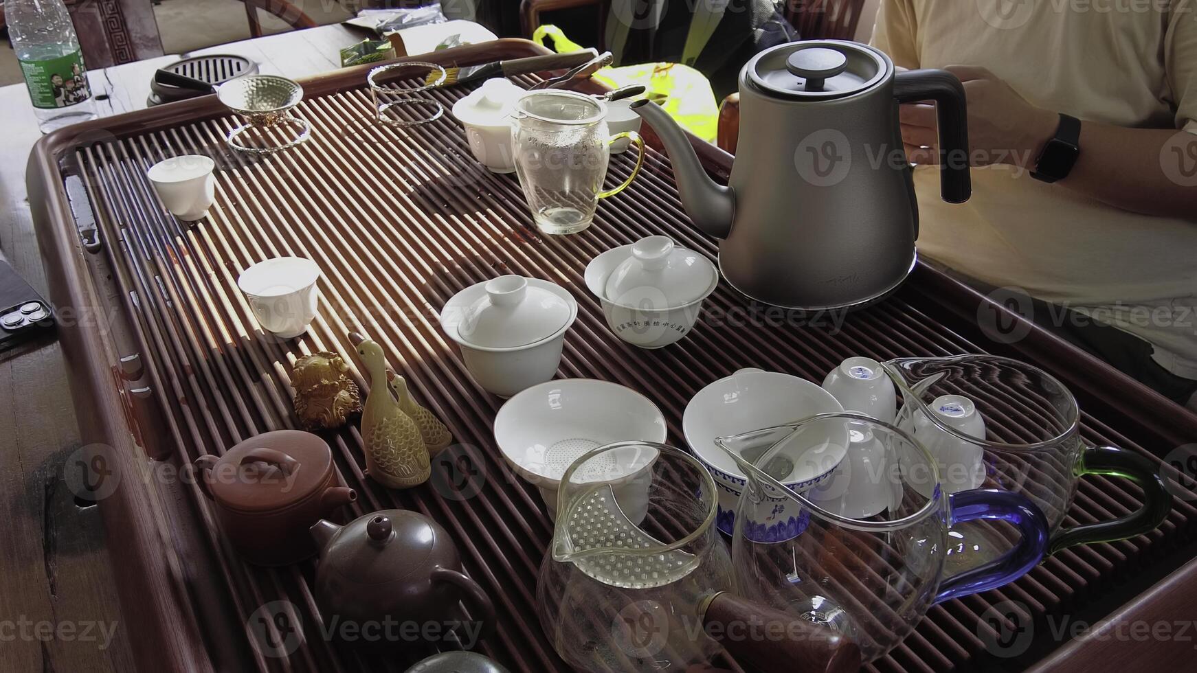 A beautiful traditional tea set display featuring various cups and teapots for tea time enjoyment. Media photo