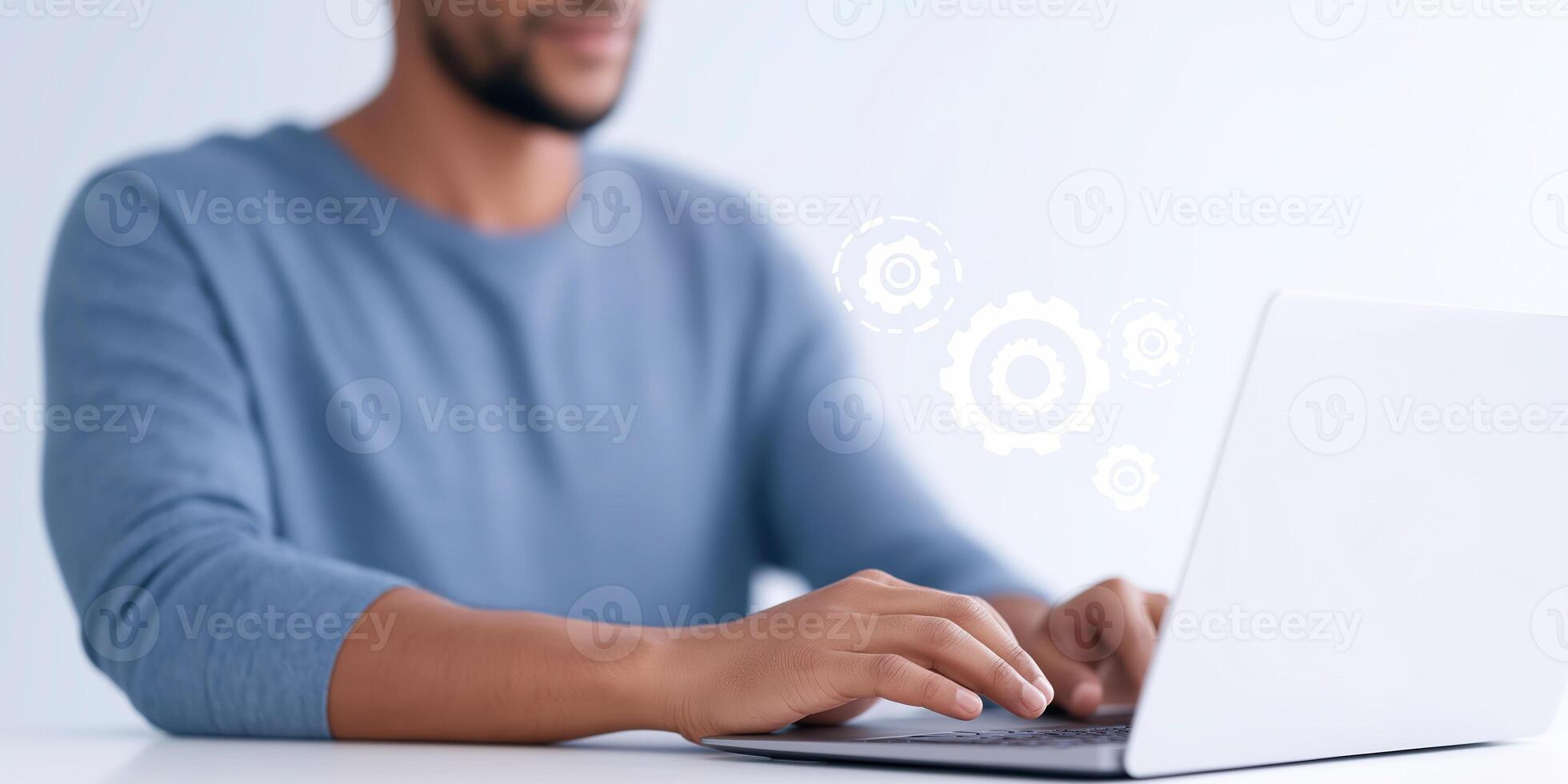 Focused man working on laptop with gears symbolizing technology and innovation in a modern workspace environment digital transformation concept photo