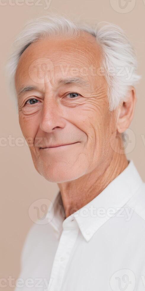 Senior man with gray hair smiling warmly, wearing a white shirt against a neutral background, showcasing confidence and wisdom, healthy aging concept photo