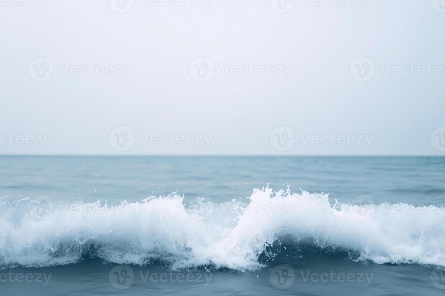 Gentle ocean waves crashing against the shore with a serene blue backdrop creating a calming atmosphere and evoking a sense of tranquility ocean waves concept photo