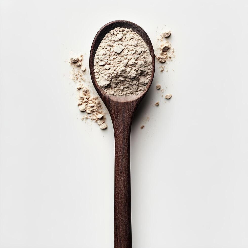 Wooden Spoon Filled with Crumbles on White Backdrop, Clean, Elegant Style photo