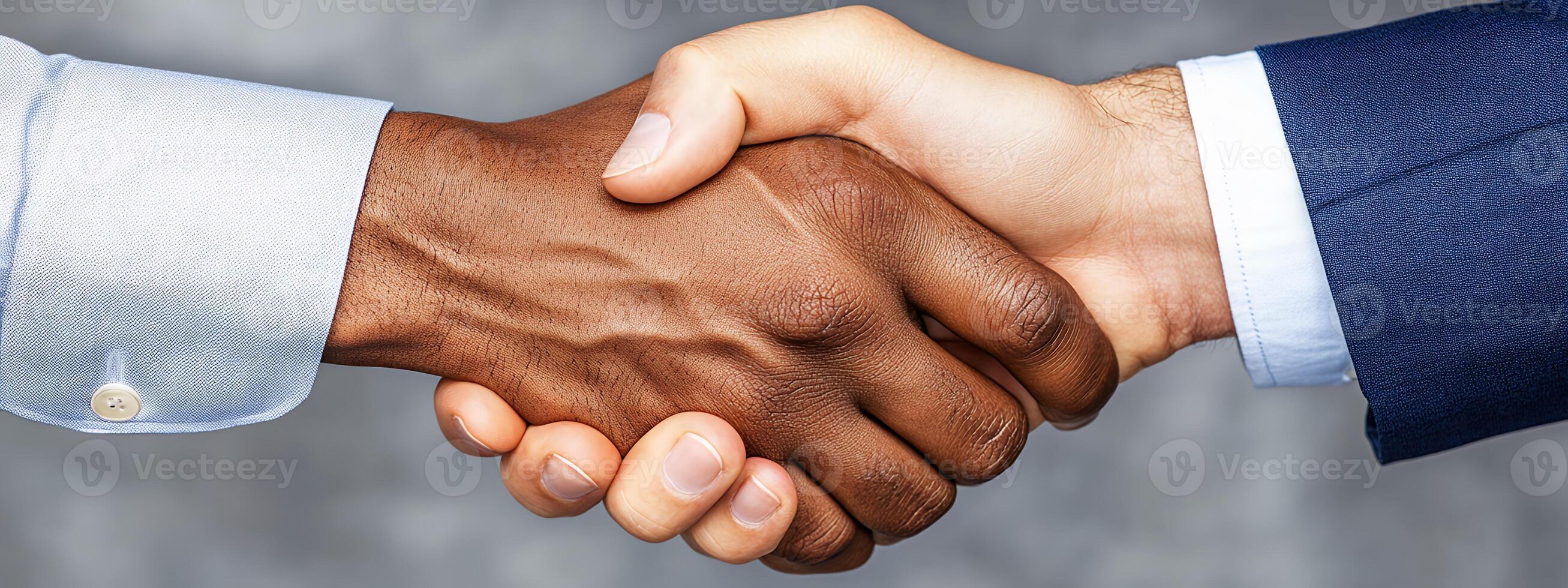 Diverse Handshake Featuring Textured Hands and Neutral Studio Background Shot photo