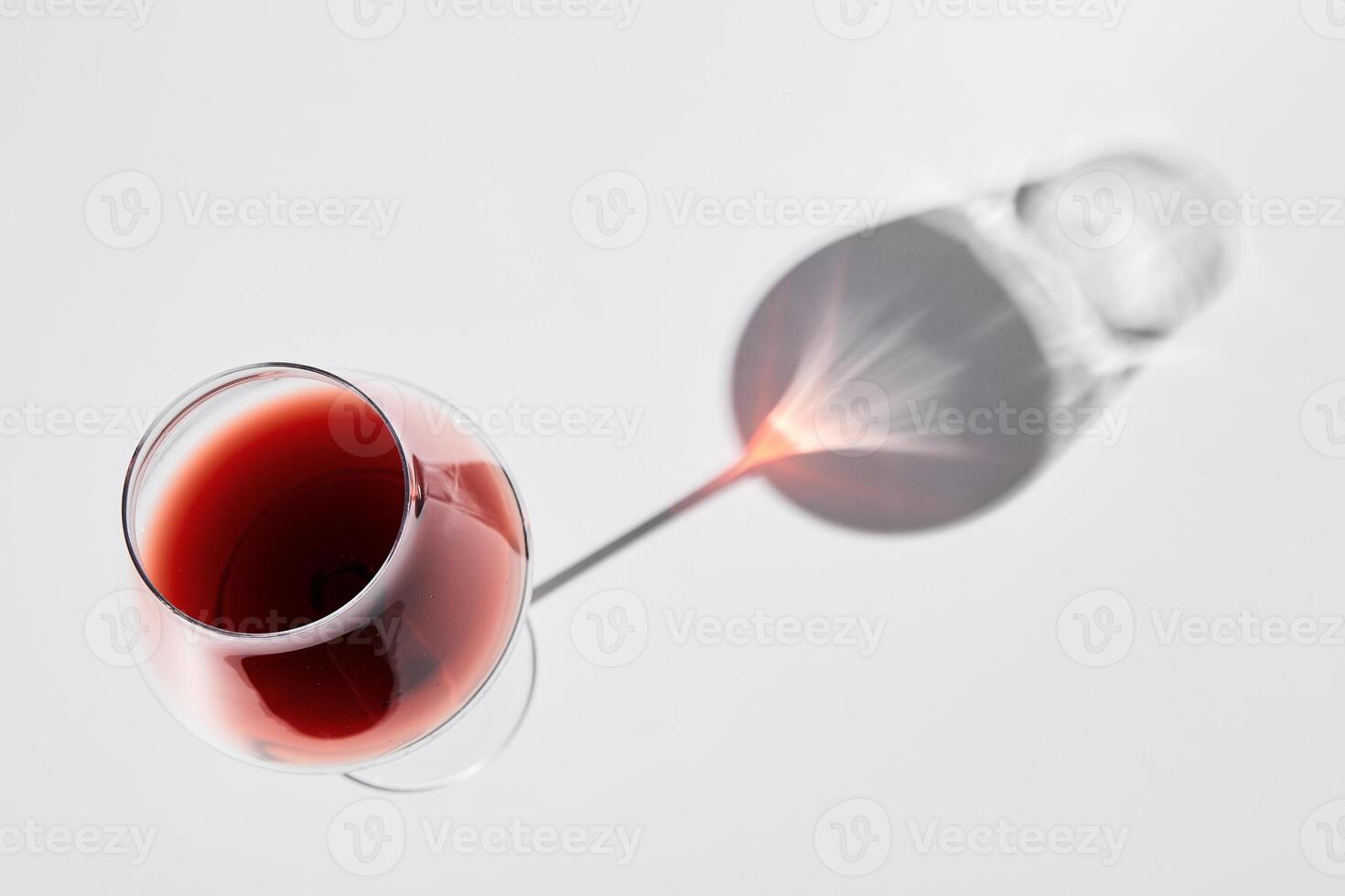 Red wine is in wineglass isolated on white background. photo