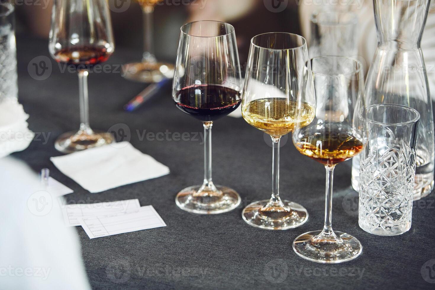 Few full wine glasses with various wine on the table, close up. Serving, service in restaurants. photo