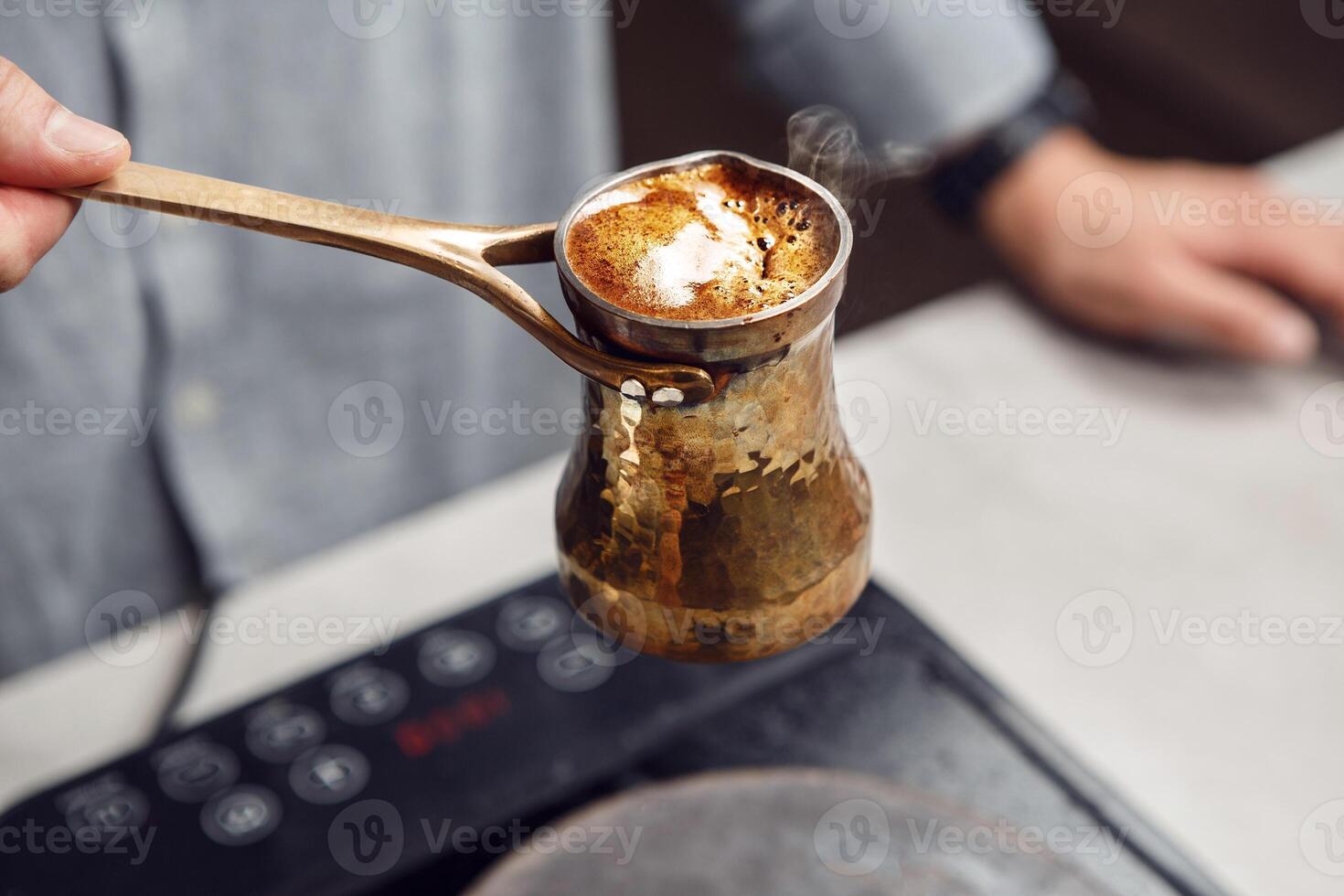 Boiling Traditional Turkish Jezve on Modern Stove Capturing the Moment of Overflow photo