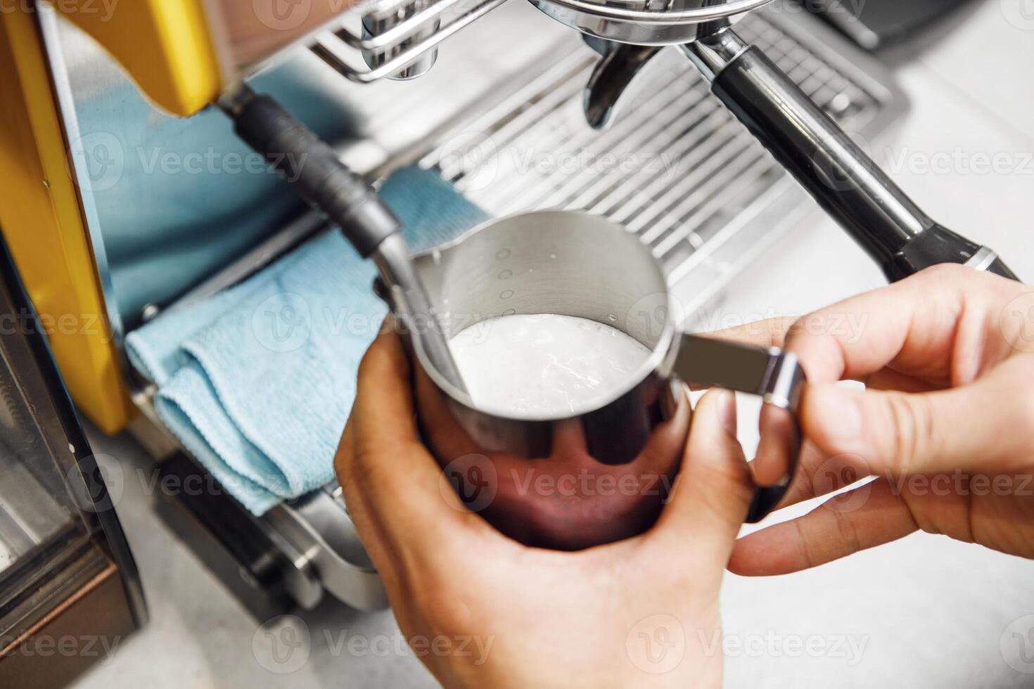 Preparing Frothy Milk Using Professional Cappuccino Machine for Coffee Beverages photo