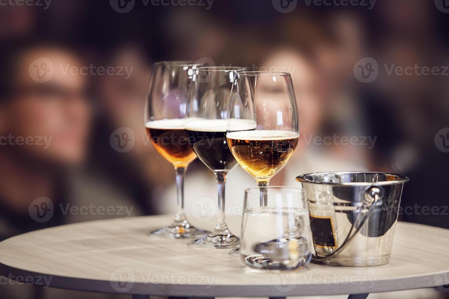 Three Different Sort of Beer in Glasses - Lager, Unfiltered and Stout on table near Spittoon, Close-up photo