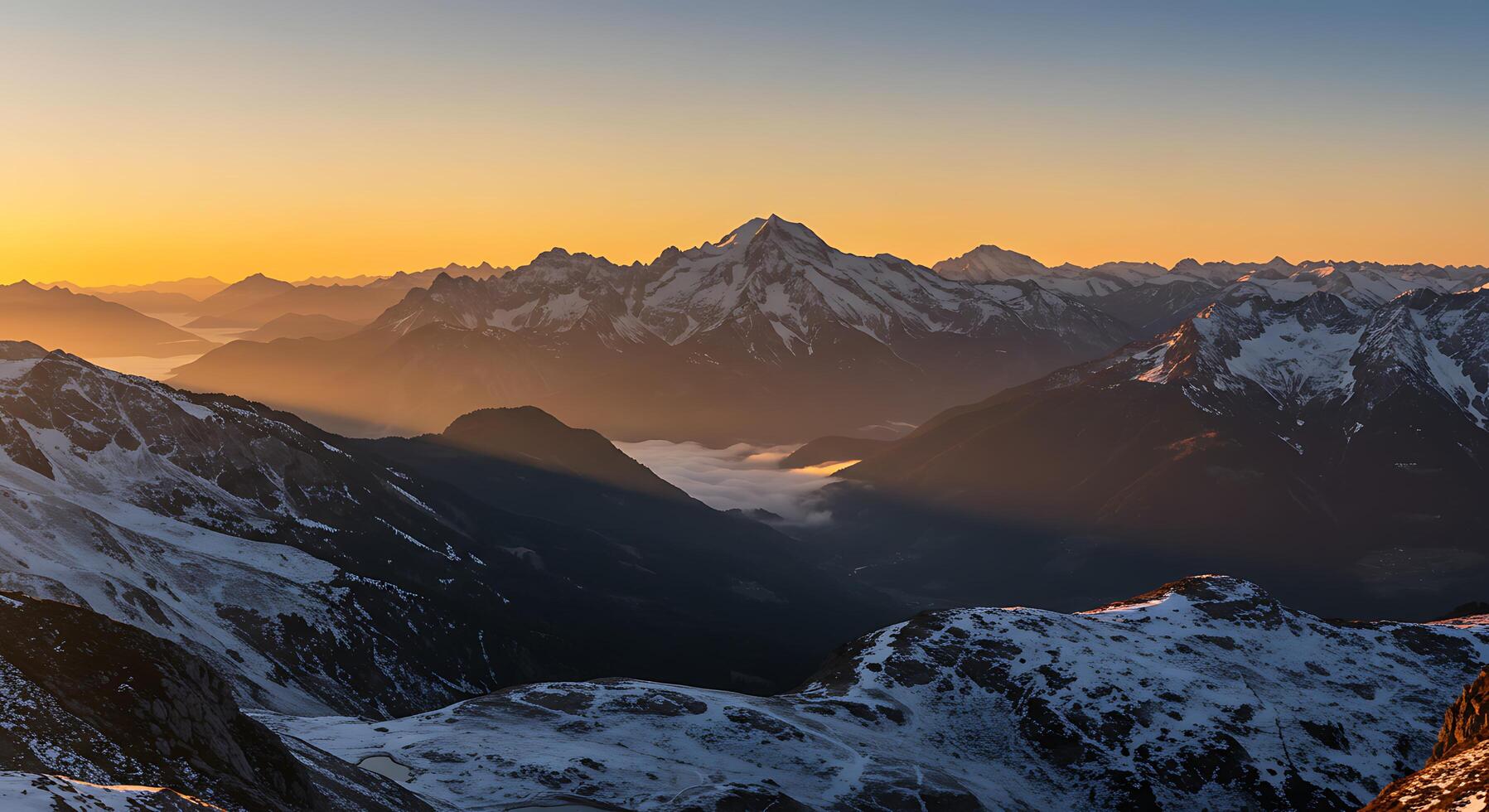 Snowy Mountain Peaks at Sunrise with Golden Light and Cloud Inversion photo